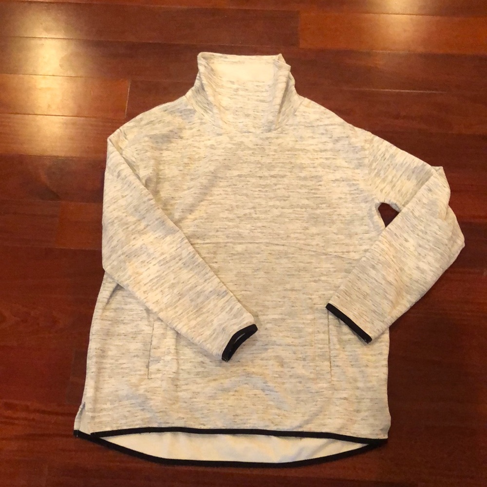 Turtle neck sweat shirt feel but almost a sweater look. Flat front pocket